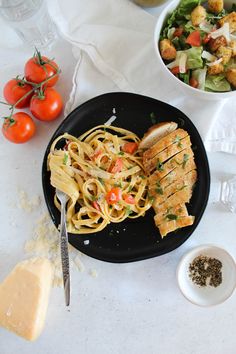 Cajun Chicken Pasta on a black plate with a salad in the background. Chilis Cajun Chicken Pasta, Work Lunch Recipes, Healthy Chili, Fettuccine Noodles, Chicken Fettuccine, Fettuccine Pasta, Cajun Chicken Pasta, Cajun Chicken, Chips And Salsa