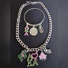 two bracelets with charms on them and one has an animal, letters, and hearts