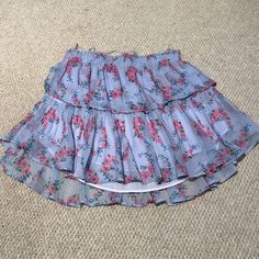 Beautiful Lsf Skirt Worn Once. Perfect Condition With No Stains, Blemishes, Or Flaws. Size Xs Fits True To Size. The Best Selling Ruffle Mini Skirt Returns For The Season With A Vibrant Floral. She Features Intricate Inset Lace Trims And Allover Pintuck Details. The Elasticated Waistband And Double Lining Offers Flexibility In Comfort And Styling. Tiered Ruffles Exude Effortless Femininity. The Mini Is Finished With A Frayed, Raw Hem For Added Playfulness. 100% Cotton. Hand Wash, Cold Water Only, Cool Iron. Lsf Skirt, Ruffle Mini Skirt, Purple Skirt, Lace Trims, Lace Inset, Pin Tucks, Pink Purple, Lace Trim, Ruffles