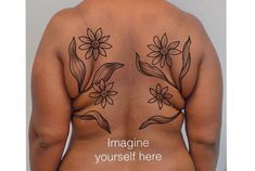 the back of a woman's body with flowers on it