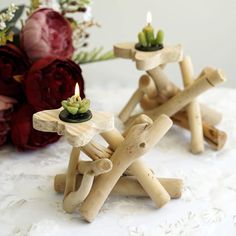 two small wooden candlesticks sitting on top of a table