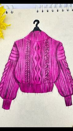 a drawing of a pink sweater on a white paper next to yellow sunflowers