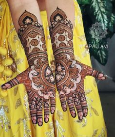 two hands with henna designs on them