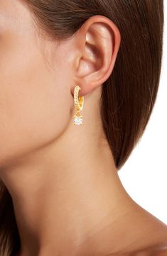 A pavé huggie earring is elongated with the elegant addition of a prong set CZ drop that for a polished and sophisticated look. 0.75" length Hinged post back 14k yellow gold plated sterling silver, cubic zirconia Imported Teardrop Prong-set Huggie Earrings, Teardrop Huggie Earrings With Prong Setting, Party Huggie Dangle Earrings, Huggie Earring, Sparkle Earrings, Natural Style, Quartz Stone, Huggies Earrings, Gold Plated Sterling Silver