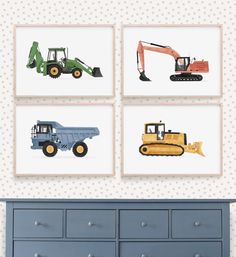 four framed pictures of construction vehicles are on the wall above a dresser in a child's room