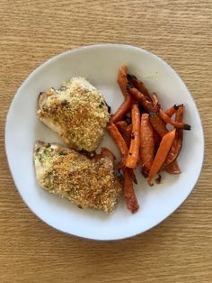 a white plate topped with chicken and carrots