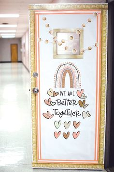 a door with the words we are better together painted on it in front of a hallway