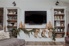 a living room decorated for christmas with stockings and stockings hanging on the fireplace mantel