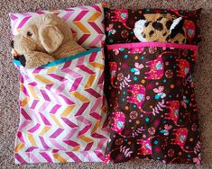 two pillows and a stuffed animal are on the floor next to each other, both with colorful designs