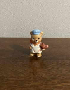 a small toy bear on a wooden table