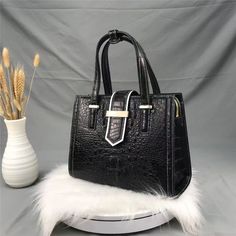 Fitted with a top handle for an elegant look, this stylish women's handbag complements your graceful persona perfectly. Crafted from genuine leather and finished in a chic alligator pattern, this casual tote is equipped with a zipper and hasp closure that ensures complete safety. A hard, spacious purse, this versatile bag is available in black and has ample room for your belongings, including a zipper pocket on the inside!Specifications Style: Fashion Size: 28cm(Length) x 22m(Height) x 12cm(Deep Alligator Pattern, Top Handle Handbags, Crocodile Skin, Casual Tote, Black Purses, Coach Swagger Bag, Black Handbags, Leather Top, Cow Leather