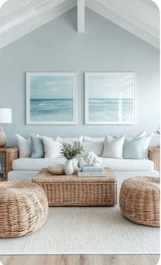 a living room with wicker furniture and paintings on the wall above it's couches