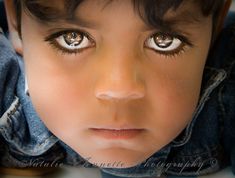 a close up of a child's face and eyes