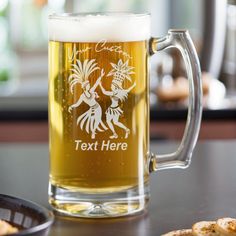 a beer mug sitting on top of a table next to crackers and a plate of food