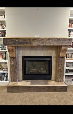 a fire place with bookshelves in the background