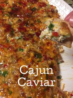 a close up of a pizza on a plate with the words cajun caviar