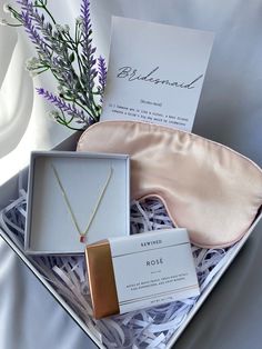 an open box containing a necklace and a card