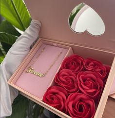 a pink box filled with red roses and a gold nameplate that says jamie on it