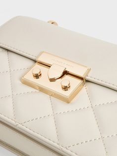 This product is made with at least 20% sustainable materials by weight. CHARLES & KEITH uses recycled, degradable, organic, and water-based materials in our eco-conscious collection. Exuding timeless elegance, this bag is destined to be a staple this season and beyond. The sleek ivory quilted finish, while understated, adds intriguing texture that elevates the classic front-flap style. Minimal gold-toned hardware imparts a luxurious quality, with the eye-catching push-lock closure ensuring both style and security for your essentials. Finished with a sophisticated chain strap, this bag will effortlessly elevate even your most casual, off-duty looks. Minimal Gold, How To Finish A Quilt, Charles Keith, Eco Conscious, Sustainable Materials, Chain Strap, Timeless Elegance, Sleek, Texture