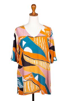 Breezy and comfortable, this cheerful rayon tunic will add a welcome splash of color to your wardrobe. Hari and Arthur in Bali design the top, which features a rounded V-neckline and three-quarter length sleeves. Vibrant Print V-neck Tunic, Multicolor Half Sleeve Tops For Beach, Printed Half Sleeve Tops For Vacation, Summer Bohemian Blouse With Bold Print, Bohemian Summer Blouse With Bold Print, Summer V-neck Tunic With Vibrant Print, Multicolor V-neck Rayon Blouse, Summer Vacation Blouse With Half Sleeves, Bohemian Blouse With Bold Print For Summer