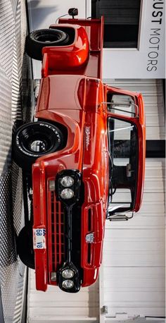 an orange truck parked inside of a garage