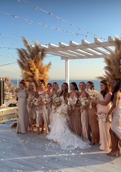 a group of women standing next to each other on top of a wooden floor covered in flowers