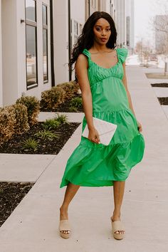 - This sweet dress is perfect for a sunny day! - Lightweight, green hued material with a lined bust - A scoop neckline - A bust with gathered detail - Flutter sleeves with elastic shoulders - A smocked upper back - A relaxed silhouette that ends in a straight midi length hemline Green Ruched Midi Dress With Square Neck, Green Ruffled Straps Vacation Dress, Green Vacation Dress With Ruffled Straps, Green Summer Midi Dress For Brunch, Green Ruched Midi Dress For Beach, Spring Green Dresses With Ruffled Straps, Green Spring Dresses With Ruffled Straps, Green Dresses With Ruffled Straps For Spring, Spring Green Ruched Midi Dress