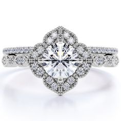 a white gold engagement ring with an oval cut diamond surrounded by pave diamonds