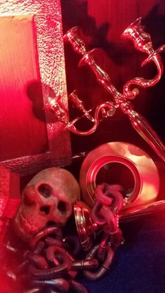 there is a skull and chains on the floor in front of a red light,