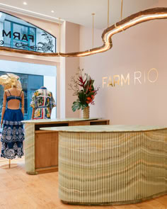 the front desk of a farm rio store with mannequins and flowers on display