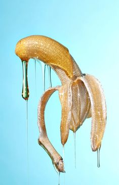 a banana hanging upside down with water dripping from it