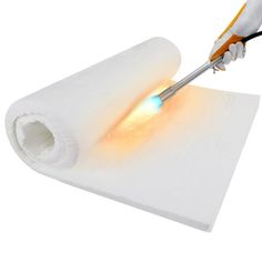 an electric toothbrush is being used to light up a piece of white paper with orange and blue lights