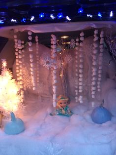 a display in the window of a store decorated with snowflakes and christmas decorations