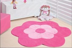 a child's room with pink furniture and accessories on the floor, including a flower rug