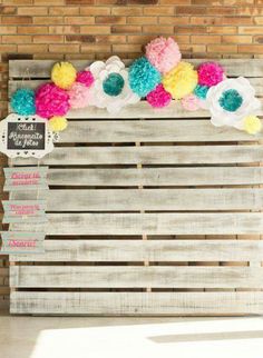 a wooden pallet decorated with pom poms