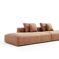 a brown couch with four pillows on it and one arm folded back to the side