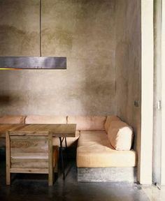 a couch and table in a room with concrete walls