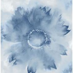 a large blue flower is shown in the middle of an image with watercolors on it