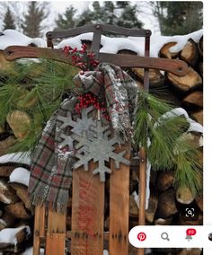 a wooden sled with a snowflake on it and a cross hanging from the front