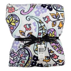 the back of a purple and white paisley print blanket with black ribbon on it's end