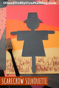 a paper cut out of a person holding a knife and fork on top of a table