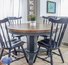 a kitchen table with four chairs around it