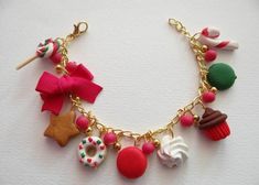 a close up of a bracelet on a white surface with doughnuts and other items