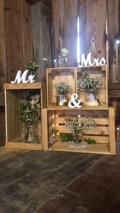 three wooden crates with flowers in them and the word mr and mrs spelled on top