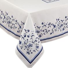 a white table cloth with blue flowers on it and a red border around the edge