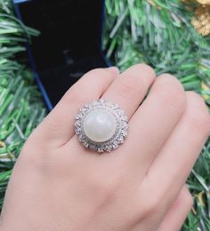 White Sea Pearl Halo Elegant Vintage Ring Pearl jewelry Stylish Ring Gift jewelry Imitation Pearl Ring jewelry Adjustable size 6-8 Exaggerated jewelry Special and unique jewelry ♥ Ready to ship ♥ The main stone is the Finest Imitation Pearl. ♥ Absolutely gorgeous and beautifully handcrafted Finest Imitation Pearl in an exquisite setting. ♥ This classic yet trendy Jewelry makes the perfect Christmas/Anniversary/Valentine's/Birthday gift for her that will be treasured forever. We have confidence t Luxury Elegant Pearl Ring With Halo Design, Luxury Halo Pearl Ring For Anniversary, Luxury Pearl Ring With Halo Design, Luxury White Pearl Ring With Halo, White Flower Ring With Center Stone As Gift, Exquisite Silver Oval Pearl Ring, Exquisite White Promise Ring, Elegant White Flower Ring With Gemstone, Pearl Ring With Cubic Zirconia For Anniversary