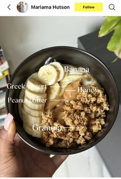 a bowl filled with granola, bananas and other toppings on top of it