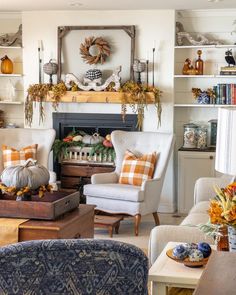 a living room filled with furniture and lots of fall decorations on the fireplace mantel