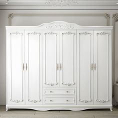 an ornate white armoire in a room