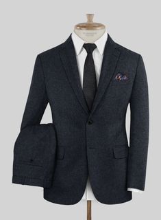 Attain a fashion-forward and contemporary flair with our Loro Piana Adriana Wool Suit. Meticulously crafted from pure wool fabric, this suit boasts a solid pattern in a captivating shade of blue infused with subtle black accents, providing a stunning enhancement to your overall look and imbuing a touch of luxury while ensuring exceptional comfort throughout the day. Whether it's a casual dinner or a high-stakes professional meeting, this suit unquestionably stands as the optimal choice, guarante Timeless Wool Suits For Office Wear, Wool Suit With Suit Collar For Office, Wool Suits With Suit Collar For Office, Elegant Winter Suits For Office Wear, Tailored Formal Winter Sets, Formal Winter Suiting Fabric Sets, Blue Formal Winter Sets, Blue Formal Sets For Winter, Elegant Blue Winter Sets